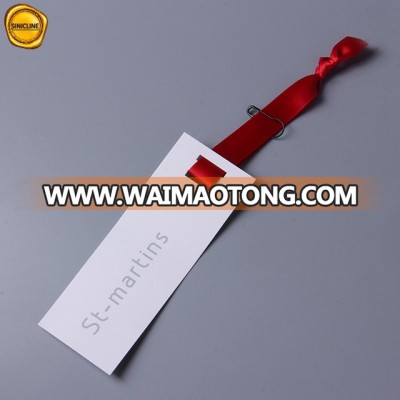 Sinicline white paper polo shirt hangtag with red grosgrain ribbon